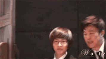 two men are standing next to each other and the word waltz is on the bottom right