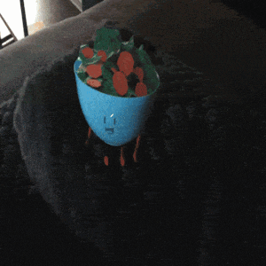 a person 's hand is reaching out towards a blue bowl on a table