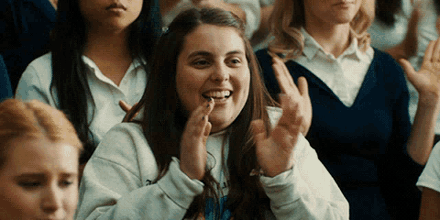 a girl in a white sweatshirt with the word reebok on it
