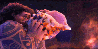 a man with a tattoo on his arm is blowing a conch shell