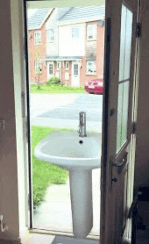 a sink is sitting outside of a doorway .