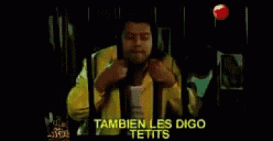 a man in a yellow jacket is standing in front of a red light and says tambien les digo tetits
