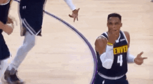 a basketball player wearing a jersey with the number 4 on it is giving a thumbs up .