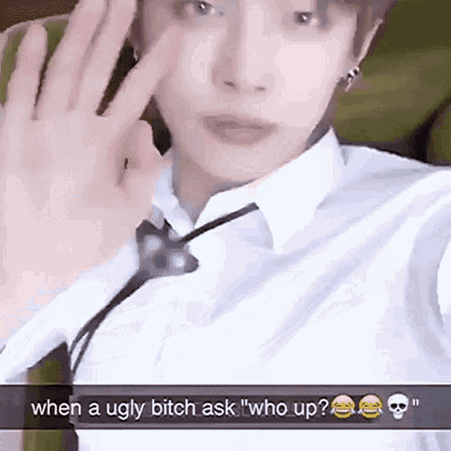 a man in a white shirt and tie is taking a selfie with his hands up .