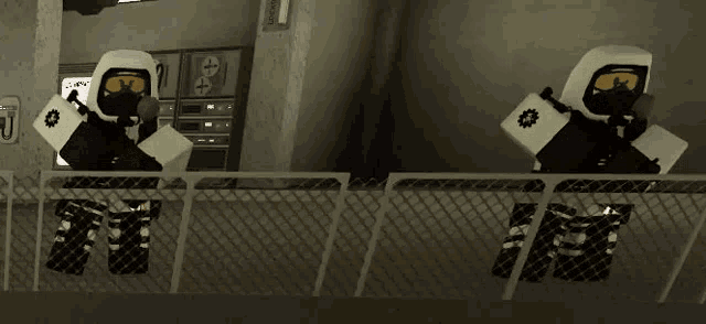 two robotic soldiers are standing next to each other on a balcony in a video game .