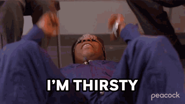 a man is laying on the floor with the words i 'm thirsty behind him
