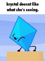a blue object with a face and arms is standing on a box .