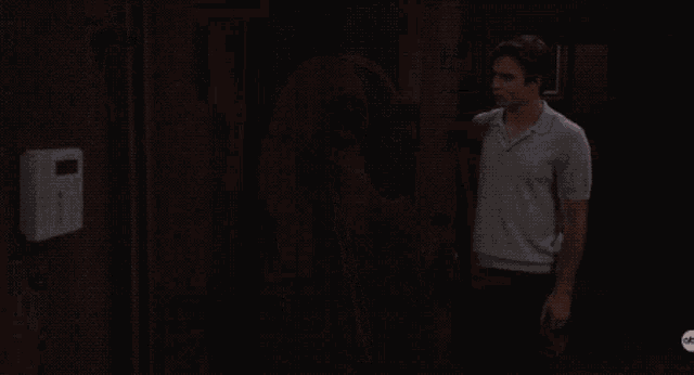a man and a woman are standing in a room with a watermark that says abc