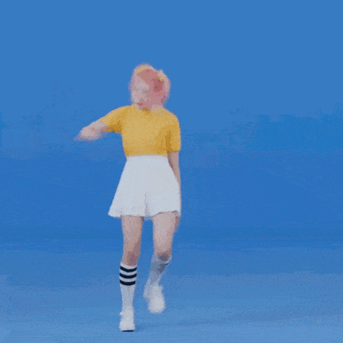 a girl with pink hair is dancing on a blue background .