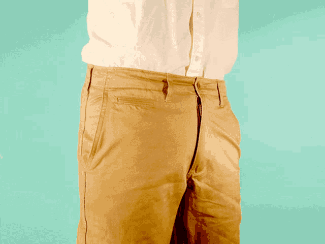 a man in a white shirt has his penis sticking out of his pants