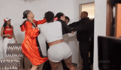 a woman in a red robe is fighting another woman in a white shirt