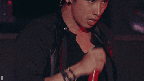 a man singing into a microphone with the letter d visible in the corner