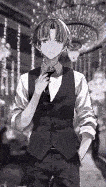 a black and white photo of a boy in a suit and tie .