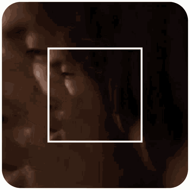 a close up of a man 's face with a white square around it