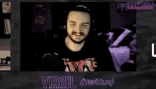 a man wearing headphones and a shirt that says the tainted is smiling