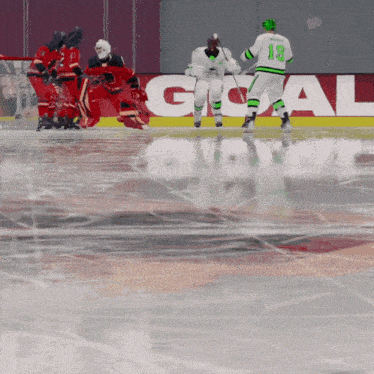 a hockey player wearing a white jersey with the number 13 on it
