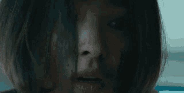 a close up of a woman 's face with her mouth open