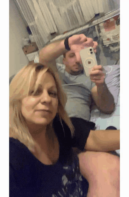 a man and a woman are taking a selfie
