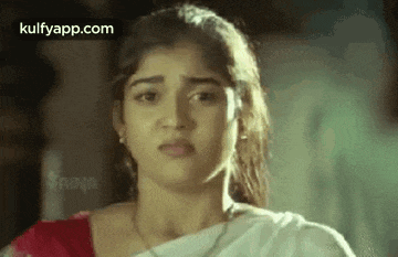 a close up of a woman 's face with a serious expression .