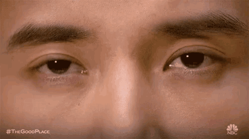 a close up of a man 's eyes with a tear coming out of one of them .