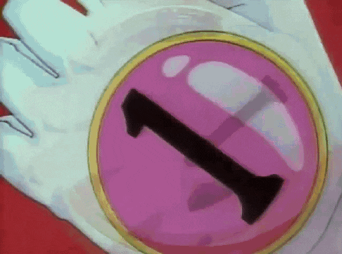 a person is holding a pink circle with the letter i on it