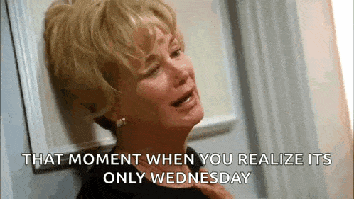 a woman is crying while leaning against a wall and says `` that moment when you realize its only wednesday '' .