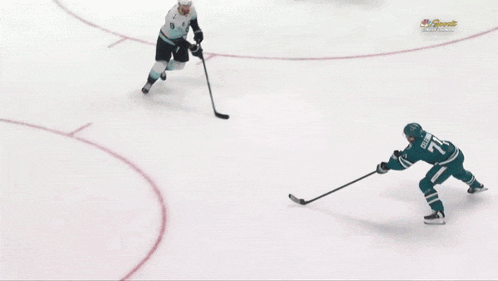a hockey game is being played in front of a sign that says cache creek casino resort