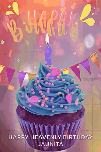 a cupcake with blue frosting and a lit candle on it