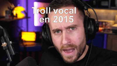 a man wearing headphones is talking into a microphone with the words troll vocal en 2015 above him