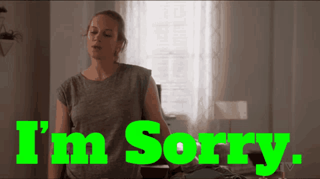 a woman says i 'm sorry in green