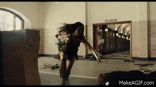 a woman in a wonder woman costume is running in a hallway with a sign that says exit only