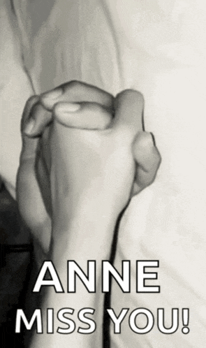 a black and white photo of two people holding hands with the words anne miss you
