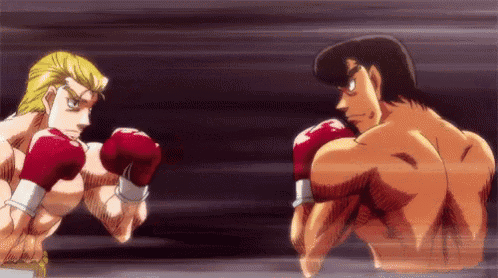 two men are boxing in a ring with red gloves on