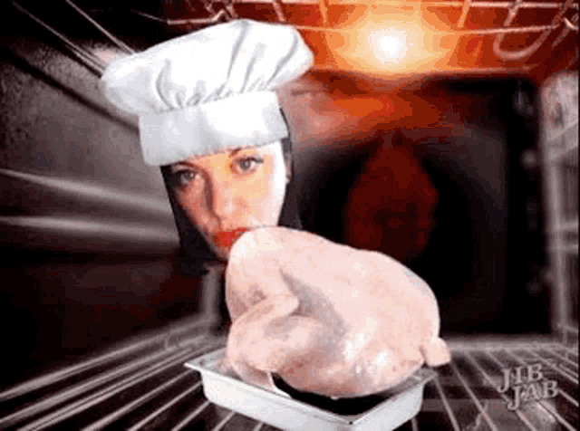 a woman in a chef 's hat is holding a turkey in a pan .