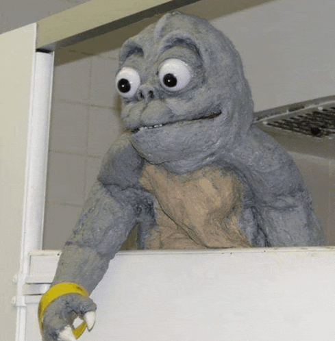 a statue of a monster with big eyes and sharp claws