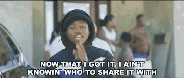 a man in a hoodie says now that i got it i ain t knowin who to share it with ..