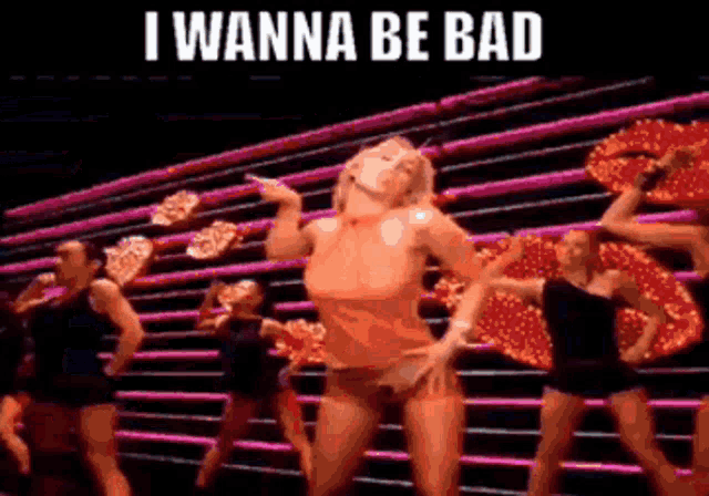 a woman is dancing with the words i wanna be bad written above her