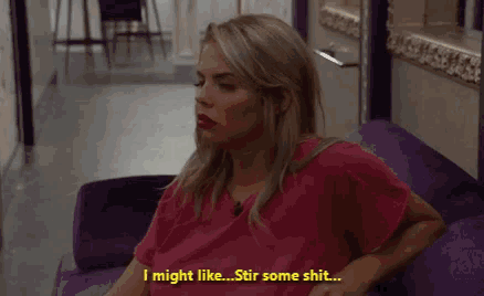 a woman in a pink shirt is sitting on a purple couch and says " i might like stir some shit "