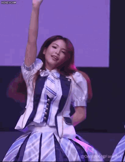 a girl in a blue and white dress is dancing