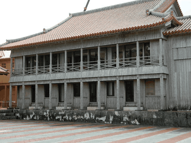 a wooden building with a red tiled roof