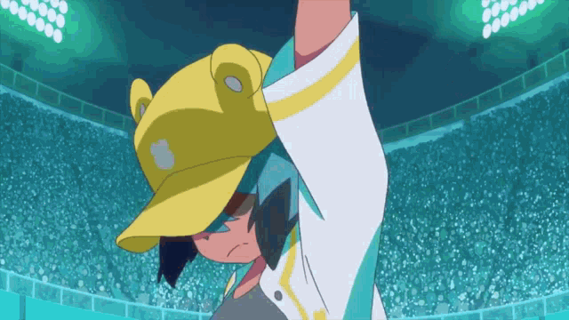 a girl wearing a yellow hat with a frog on it
