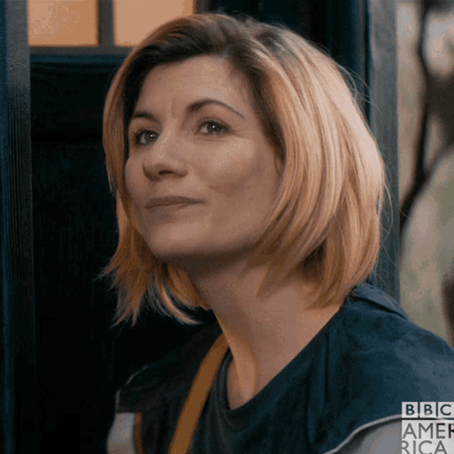 a close up of a woman 's face with a bbc america shirt on