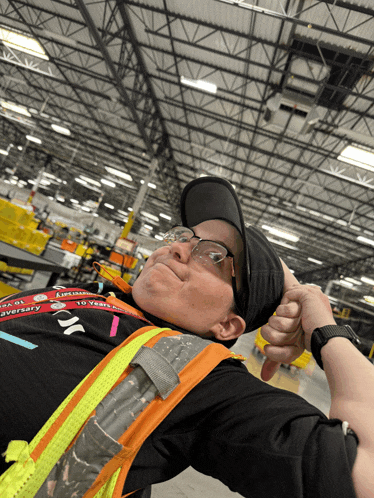 a man in a warehouse wearing a lanyard that says 10 years on it
