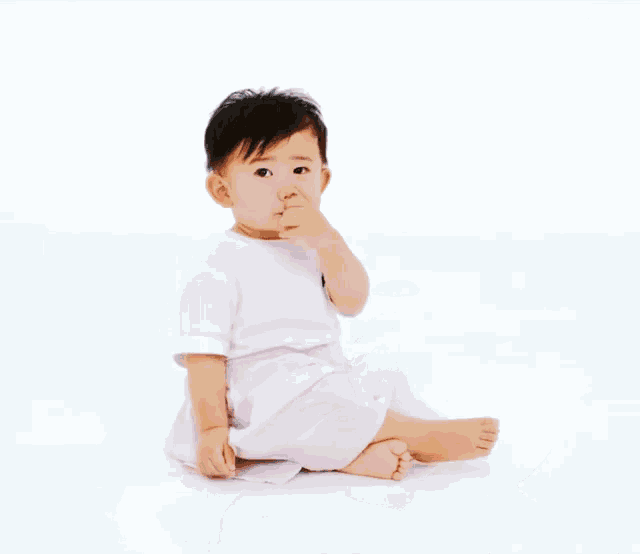 a baby is crawling on the floor and smiling .