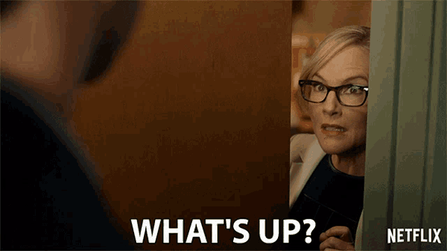 a netflix advertisement shows a woman peeking out of a door and asking what 's up