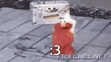 elmo from sesame street is standing next to a cassette tape