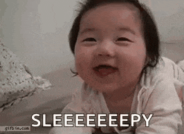 a baby is laying on its stomach on a bed .