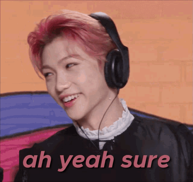 a young man wearing headphones with the words ah yeah sure behind him