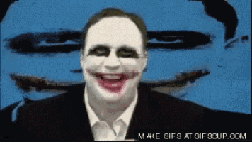 a man with a joker face painted on his face is smiling in front of a blue background