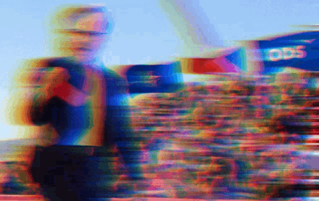 a blurry photo of a man standing in front of a sign that says ods